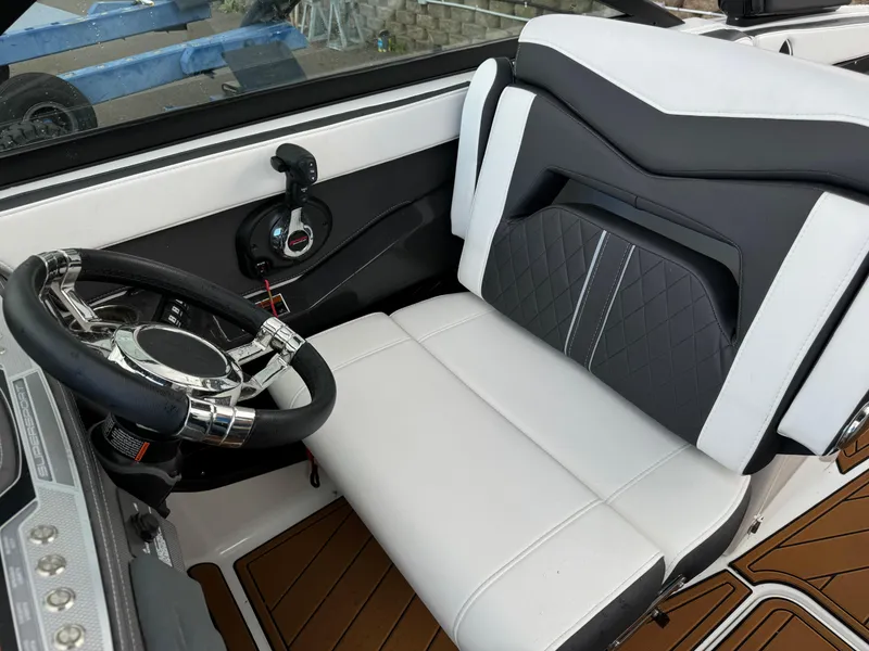 Slide: The Image of 2022 Monterey 258 Super Sport boat interior with sleek steering wheel and modern seating design. - 22