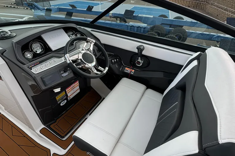 Slide: The Image of 2022 Monterey 258 Super Sport boat interior with sleek dashboard and comfortable seating. - 23