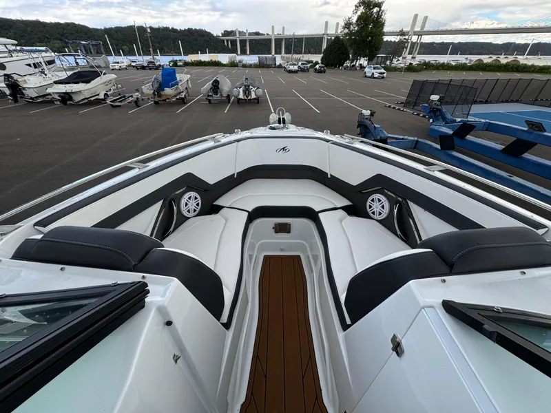 Slide: The Image of 2022 Monterey 258 Super Sport boat with sleek seating and modern design in a marina setting. - 29