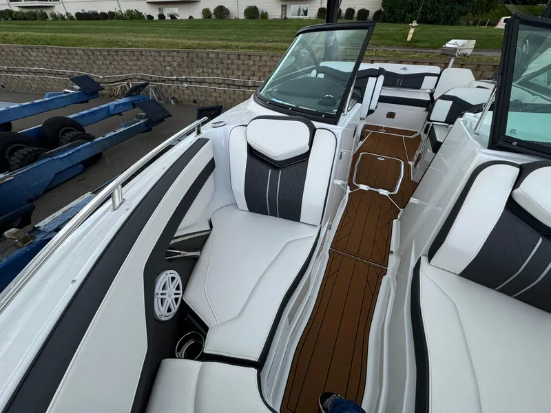 Slide: The Image of 2022 Monterey 258 Super Sport boat interior with white seating and brown deck. - 35
