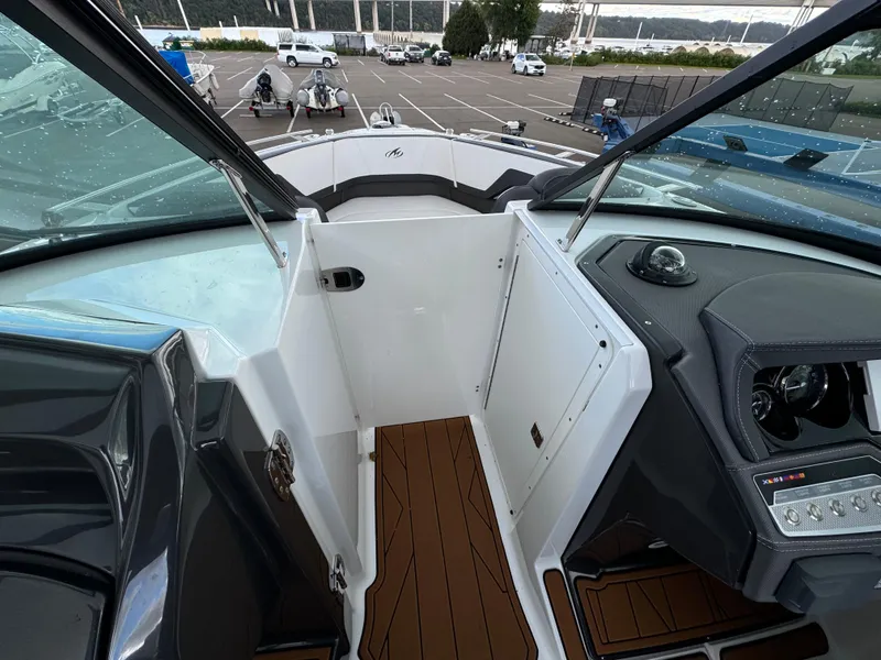 Slide: The Image of 2022 Monterey 258 Super Sport boat interior with wood flooring and control panel. - 39