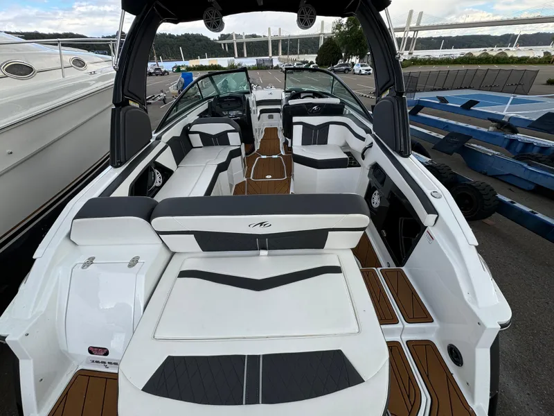 Slide: The Image of 2022 Monterey 258 Super Sport boat with sleek interior and modern design, docked at marina. - 9