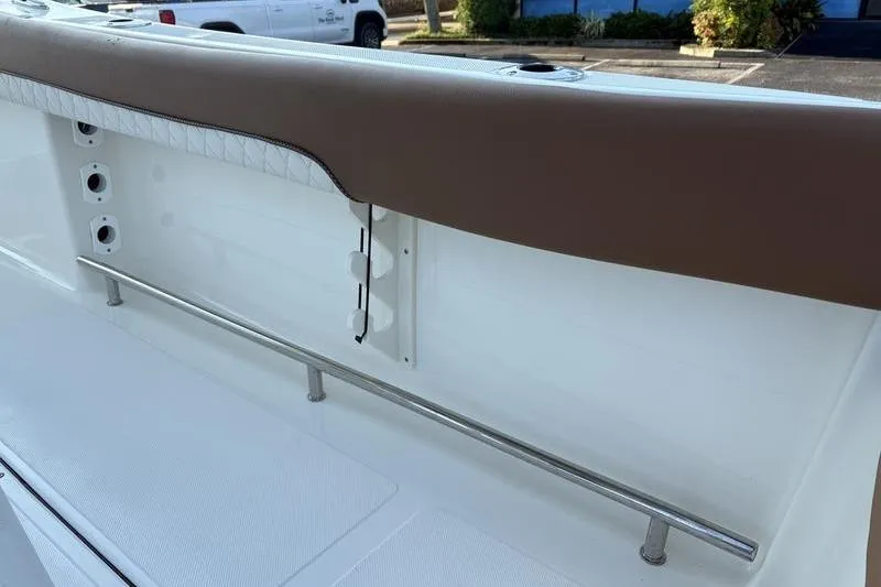 Slide: The Image of 2026 Pioneer Islander 222 boat interior with cushioned seating and stainless steel railing. - 13