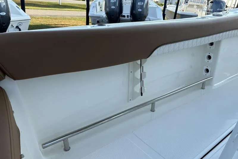 Slide: The Image of 2026 Pioneer Islander 222 boat interior with cushioned seating and stainless steel railing. - 14