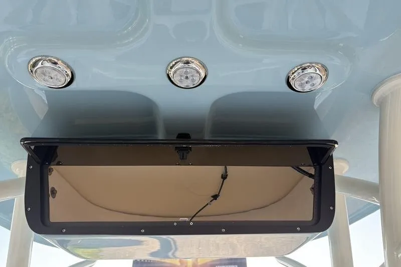 Slide: The Image of 2026 Pioneer Islander 222 boat console with three LED lights and storage compartment. - 18