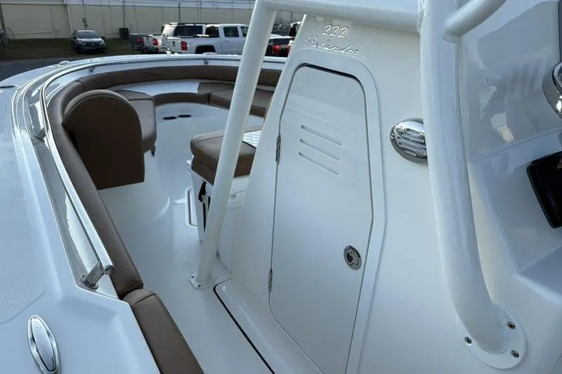 Slide: The Image of 2026 Pioneer Islander 222 boat interior with brown seating and white console. - 23