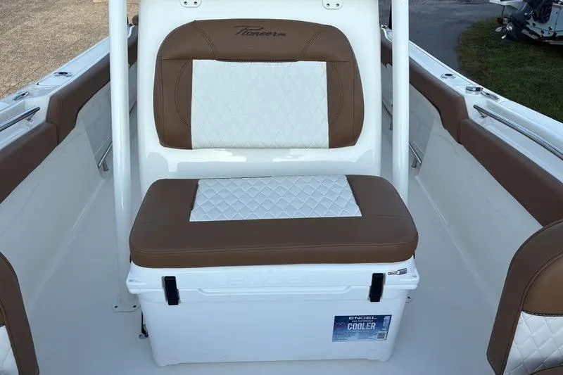 Slide: The Image of 2026 Pioneer Islander 222 boat seat with integrated cooler, featuring brown and white upholstery. - 27