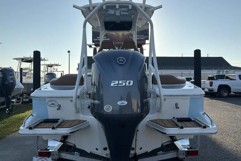 Slide: The Image of 2026 Pioneer Islander 222 boat with Yamaha 250 engine, rear view in marina setting. - 3