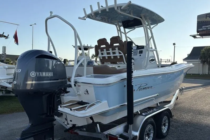 Slide: The Image of 2026 Pioneer Islander 222 boat with Yamaha engine on trailer, parked outdoors. - 4