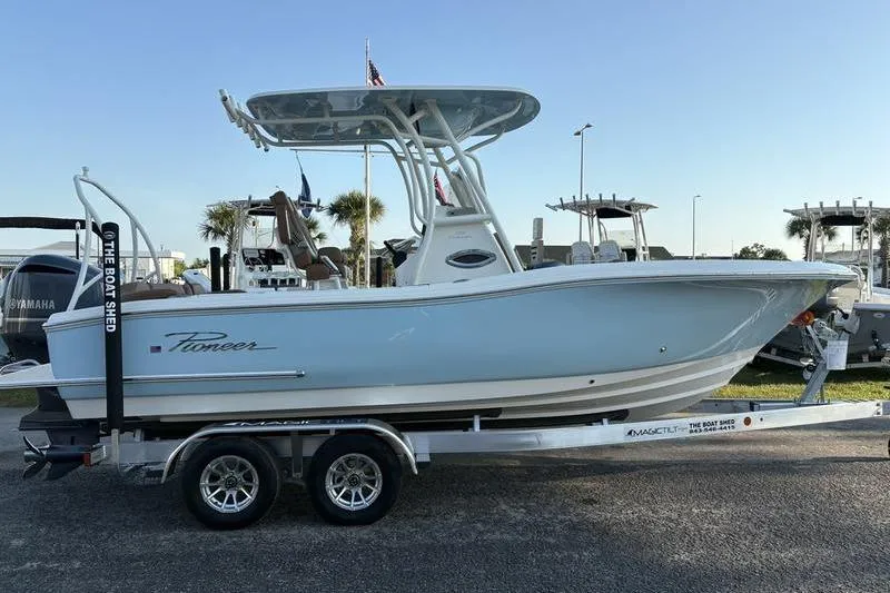 Slide: The Image of 2026 Pioneer Islander 222 boat on trailer, displayed outdoors. - 5
