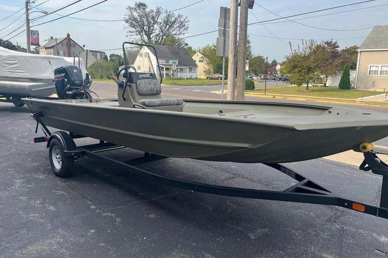 Slide: The Image of 2026 Tracker Grizzly 1860 CC boat on trailer, parked in suburban neighborhood. - 2