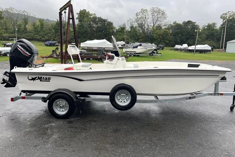 The Image of 2026 Mako Pro Skiff 17 CC boat on trailer, parked outdoors on a cloudy day. - 0