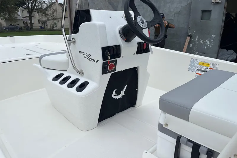 Slide: The Image of 2026 Mako Pro Skiff 17 CC boat interior with steering console and seating. - 7