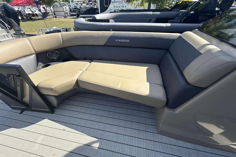 Slide: The Image of Luxurious seating on 2026 Viaggio x22u boat, featuring beige and gray upholstery. - 12