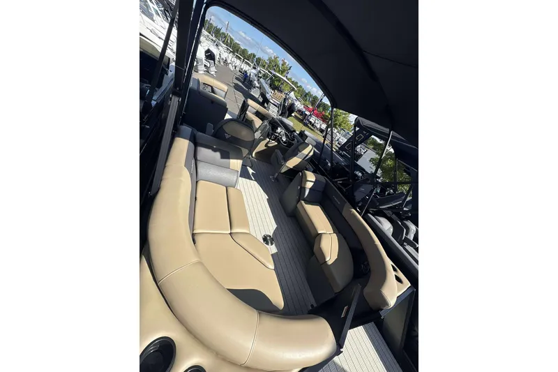 Slide: The Image of 2026 Viaggio x22u boat interior with tan seating and canopy, docked at marina. - 16