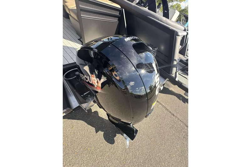 Slide: The Image of Black Mercury outboard motor on Viaggio x22u boat, 2026 model, reflecting sky and surroundings. - 21