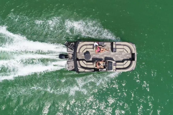 Slide: The Image of Aerial view of 2026 Viaggio x22u boat cruising on green water. - 22