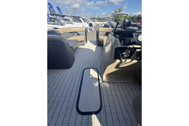 Slide: The Image of 2026 Viaggio x22u boat interior with spacious seating and modern dashboard under clear skies. - 9