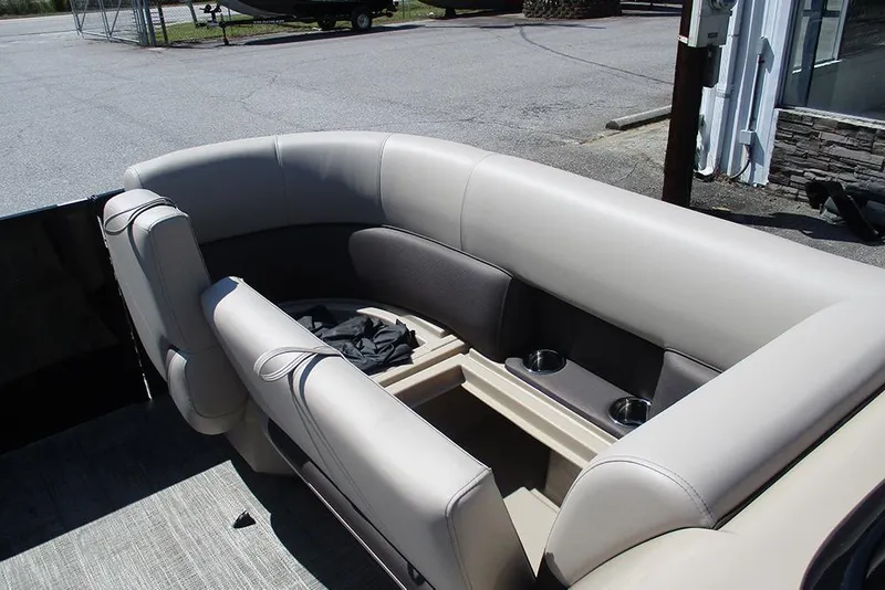 Slide: The Image of 2026 Bentley Pontoons 223 Legacy Swingback interior with beige seating and cup holders. - 13