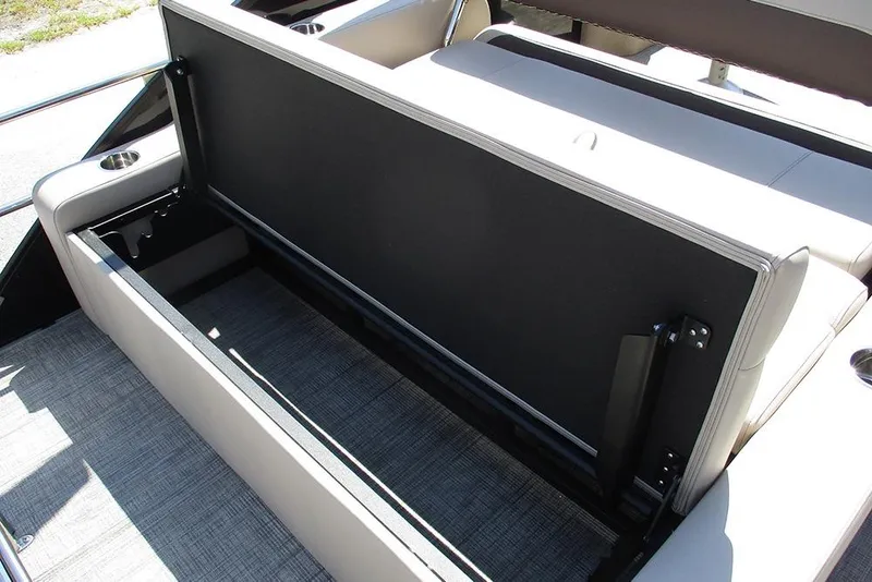 Slide: The Image of 2026 Bentley Pontoons 223 Legacy Swingback storage compartment with open seat and cup holders. - 25