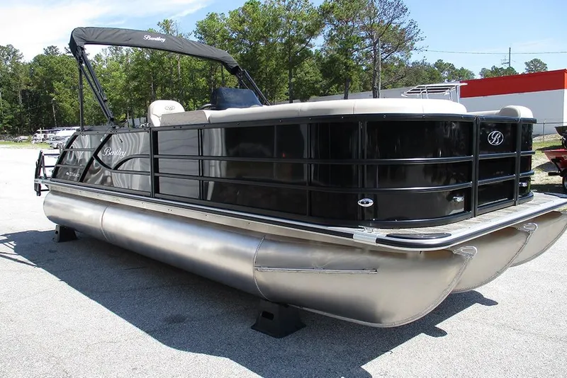 Slide: The Image of 2026 Bentley Pontoons 223 Legacy Swingback, sleek black design, parked outdoors. - 5