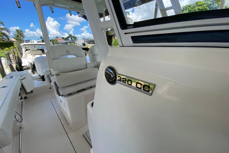 Slide: The Image of 2015 Edgewater 320CC boat interior with seating and model emblem. - 18