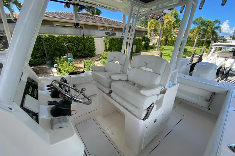 Slide: The Image of 2015 Edgewater 320CC boat interior with helm, dual seats, and modern controls. - 21