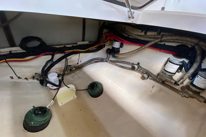 Slide: The Image of Interior view of 2015 Edgewater 320CC boat showing wiring and plumbing components. - 35