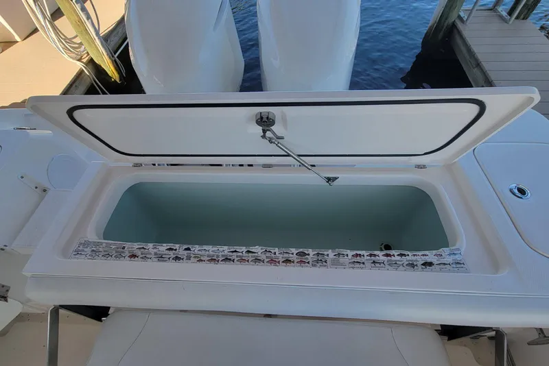 Slide: The Image of Open storage compartment on 2015 Edgewater 320CC boat, dockside view. - 9