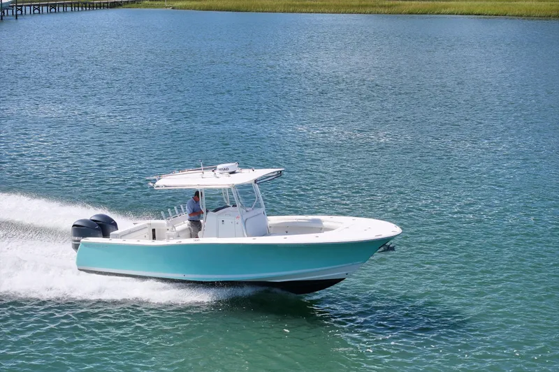 Slide: The Image of 2006 Southport 28 Center Console boat cruising on clear blue water. - 10
