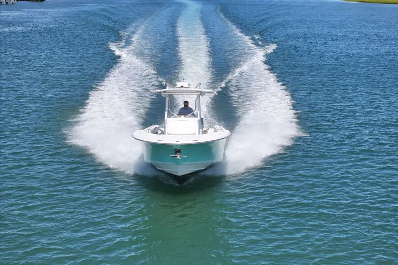 Slide: The Image of 2006 Southport 28 Center Console boat cruising on open water, creating a wake. - 11