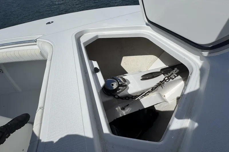 Slide: The Image of Open anchor compartment on 2006 Southport 28 Center Console boat, showing chain and anchor. - 14