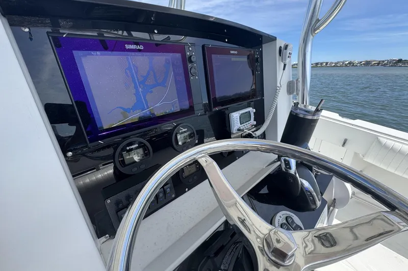 Slide: The Image of Steering console of 2006 Southport 28 Center Console boat with navigation screens. - 17