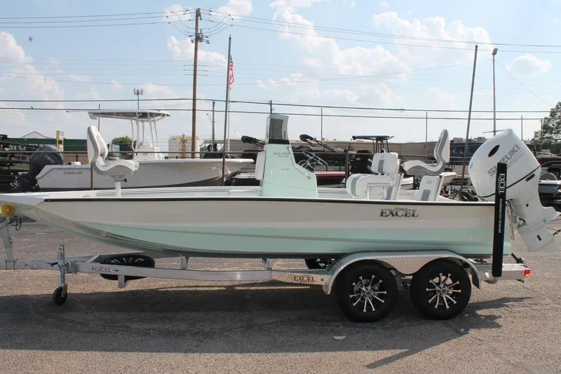 Slide: The Image of 2026 Excel Bay Pro Elite 203 boat on trailer, parked outdoors. - 10