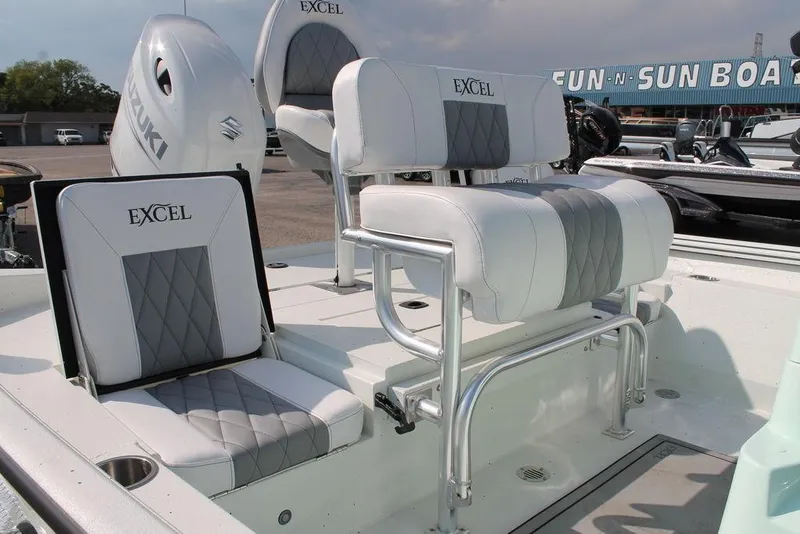 Slide: The Image of 2026 Excel Bay Pro Elite 203 boat seats with Suzuki engine in a showroom. - 3
