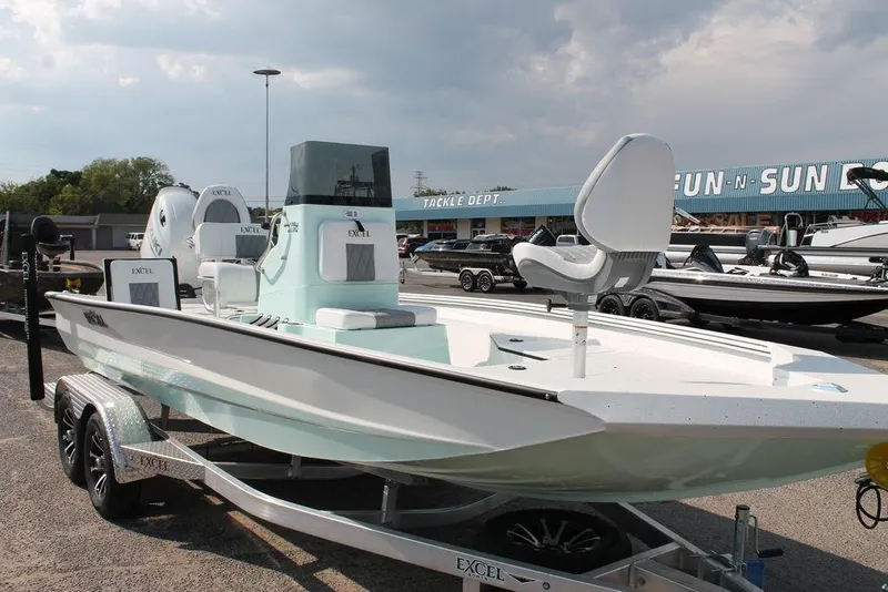 Slide: The Image of 2026 Excel Bay Pro Elite 203 boat on trailer at dealership, under cloudy sky. - 8