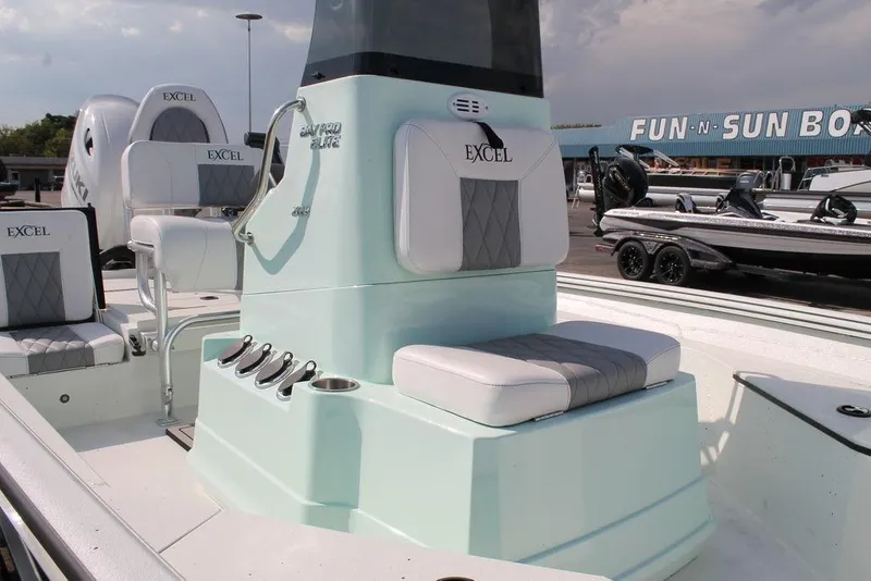 Slide: The Image of 2026 Excel Bay Pro Elite 203 boat interior with cushioned seating and control panel. - 9