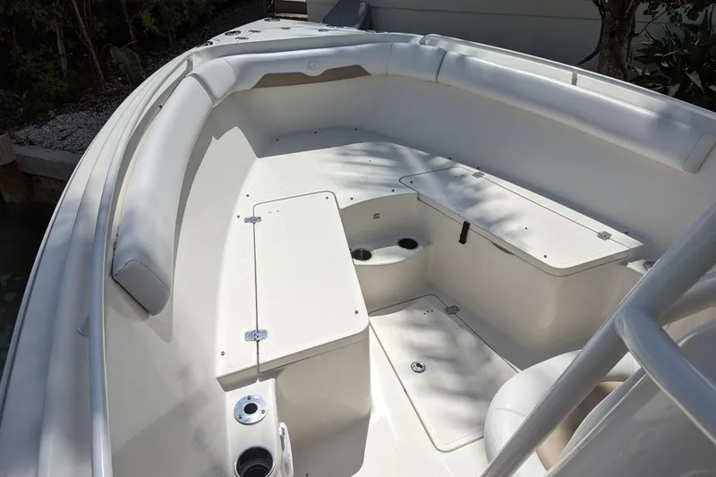 Slide: The Image of 2016 Sailfish 240 CC boat interior with cushioned seating and storage compartments. - 11
