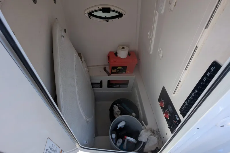 Slide: The Image of Interior of 2016 Sailfish 240 CC boat with storage and control panel. - 7