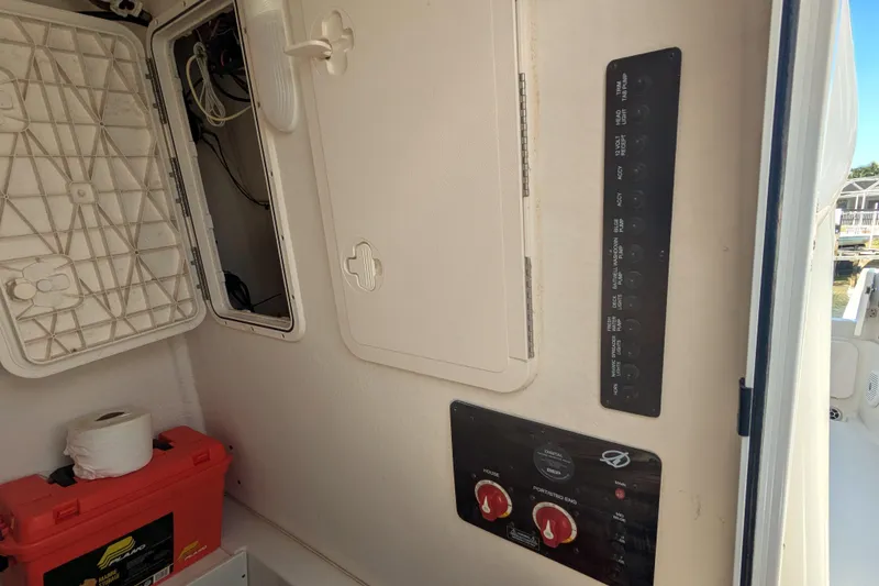 Slide: The Image of 2016 Sailfish 240 CC boat interior with control panel and storage compartments. - 8