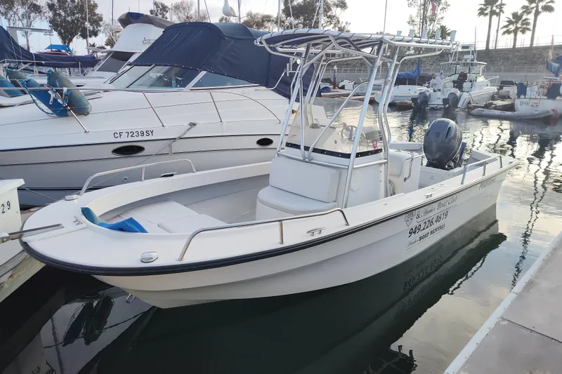 Slide: The Image of 2021 Maritime 2090 Skiff boat docked at marina, featuring center console and outboard motor. - 2