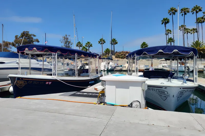 Slide: The Image of 2021 Maritime 2090 Skiff boat docked, showcasing steering console and railings. - 4