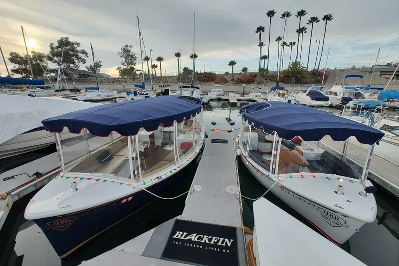 Slide: The Image of 2021 Maritime 2090 Skiff boats docked at a marina under clear blue skies. - 6