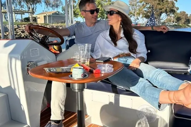 Slide: The Image of Couple relaxing on a 2021 Maritime 2090 Skiff boat, enjoying a sunny day. - 9