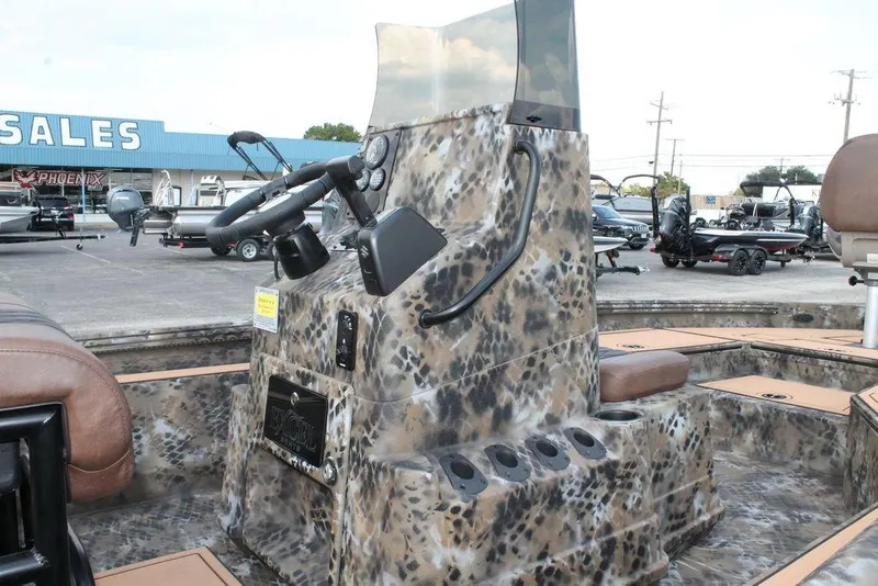 Slide: The Image of 2026 Excel Bay Pro Elite 203 boat interior with camouflage design at dealership. - 10