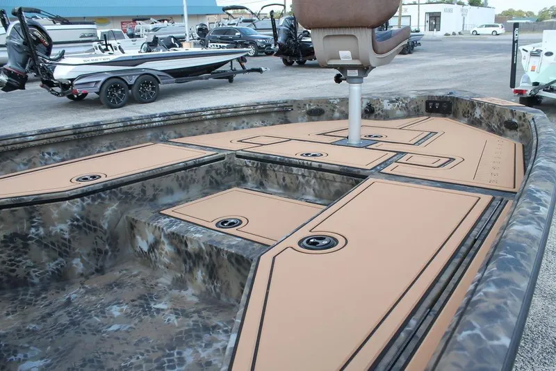 Slide: The Image of 2026 Excel Bay Pro Elite 203 boat interior with camo design and seating. - 11