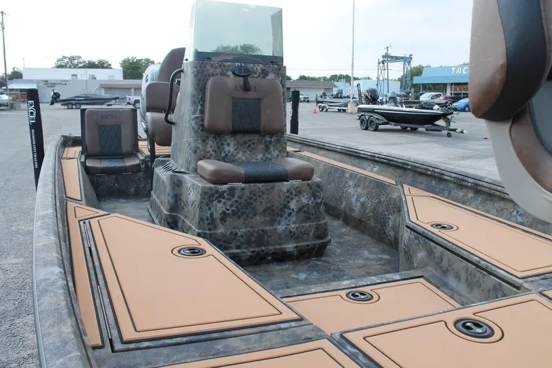 Slide: The Image of 2026 Excel Bay Pro Elite 203 boat interior with camo design and tan accents. - 12