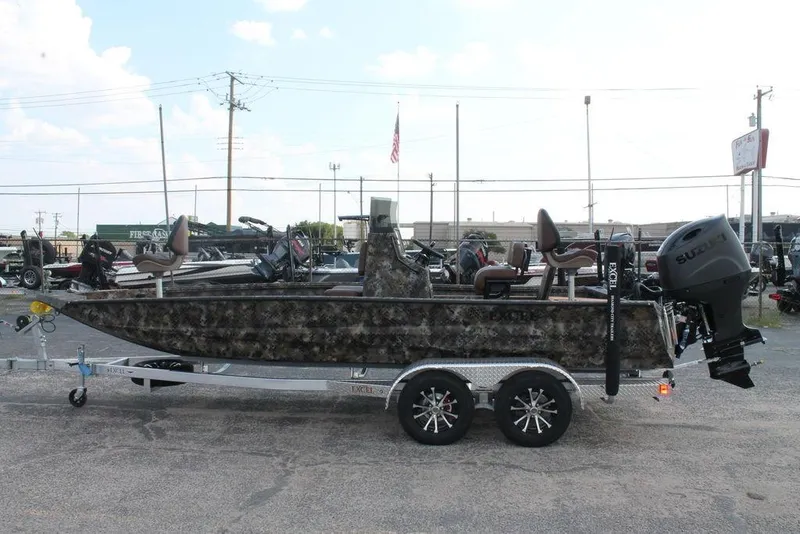 Slide: The Image of 2026 Excel Bay Pro Elite 203 boat on trailer, camo design, Suzuki outboard motor. - 3