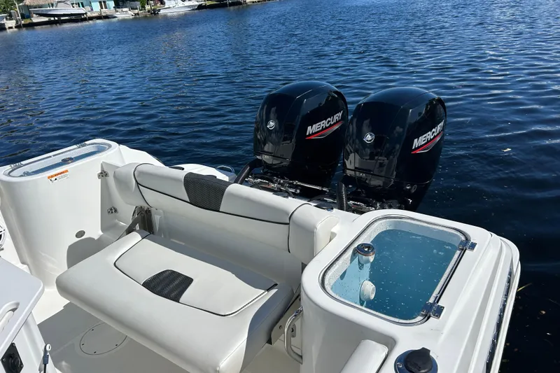 Slide: The Image of 2022 Wellcraft 242 Fisherman boat with dual Mercury engines on a calm lake. - 12