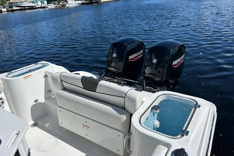 Slide: The Image of 2022 Wellcraft 242 Fisherman boat with twin Mercury engines on a calm lake. - 15